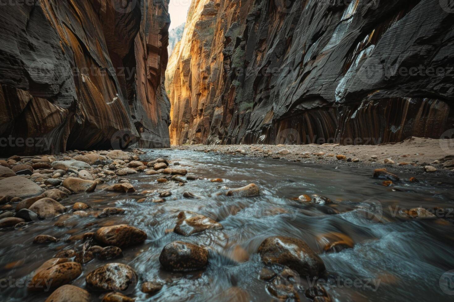 A river runs through a canyon with a rocky shoreline photo