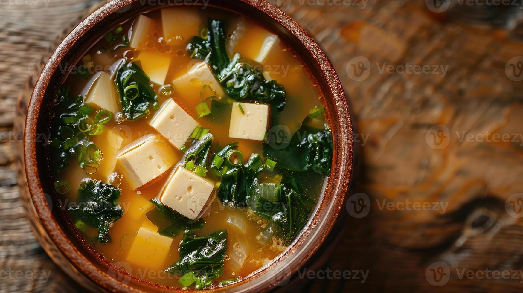 Close-up of a Bowl of Miso Soup with Tofu and Greens photo