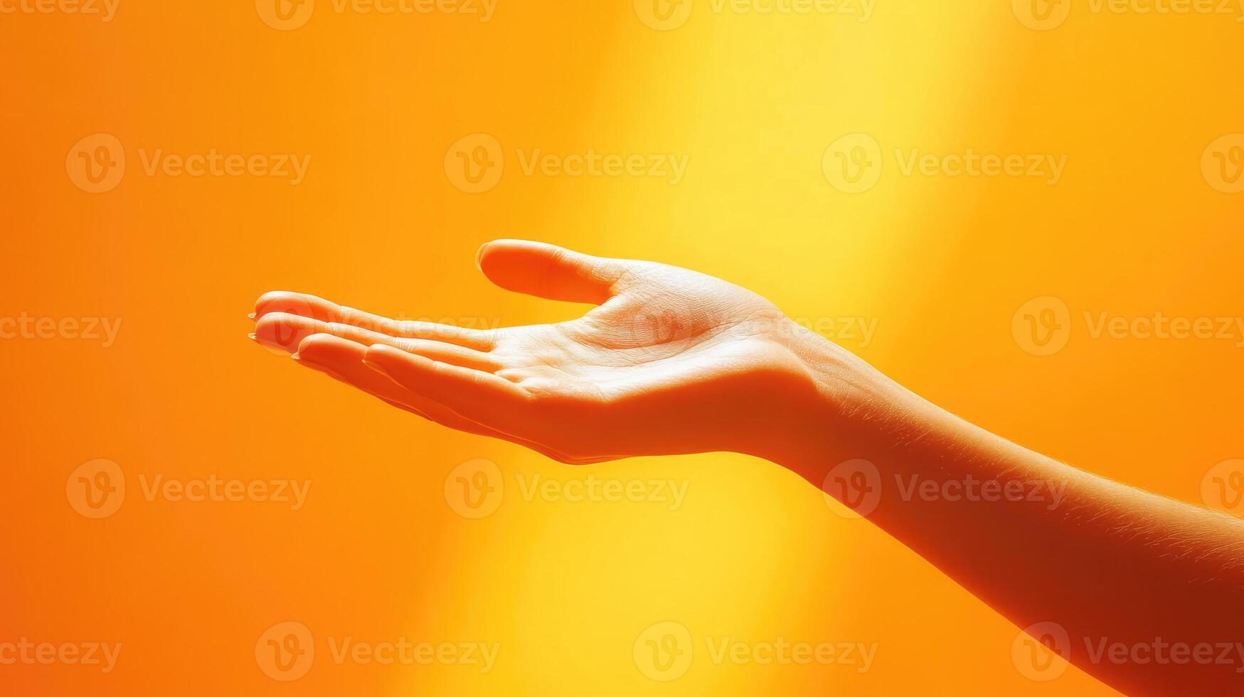 An Open Palm Reaching Upward Against a Warm Orange Background photo