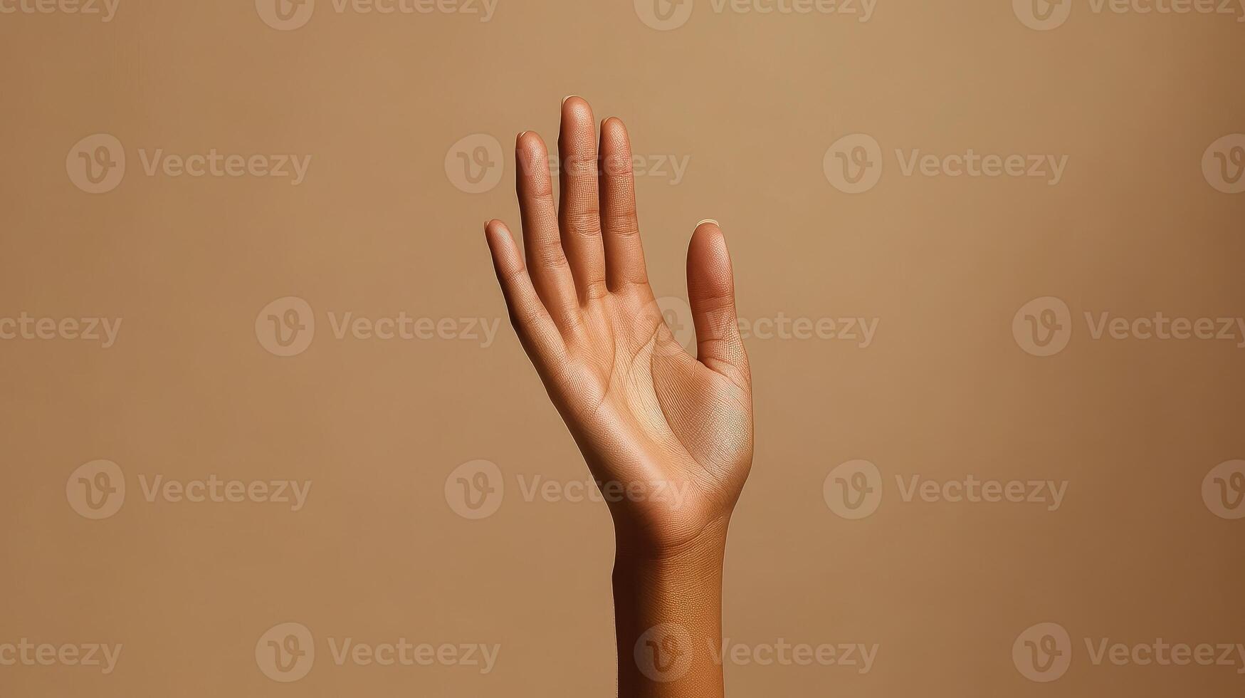 A Close-Up View of an Open Hand Against a Light Brown Background photo