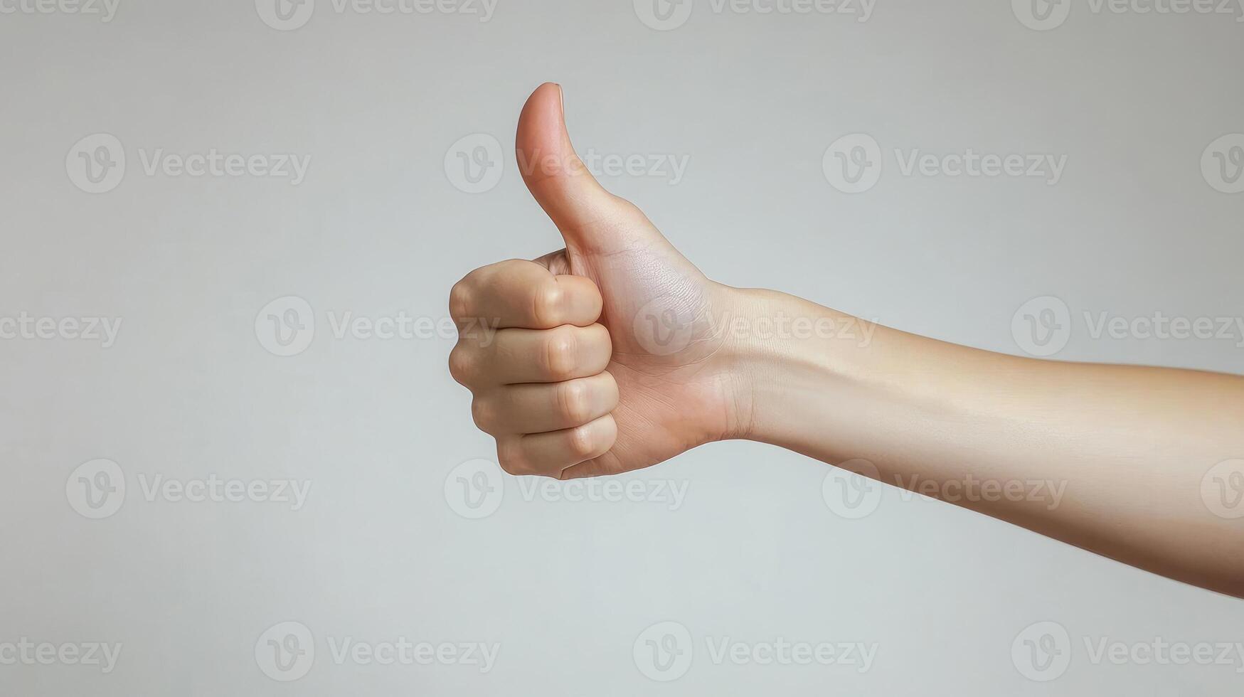 A Close-Up of a Hand Giving a Thumbs-Up Gesture photo