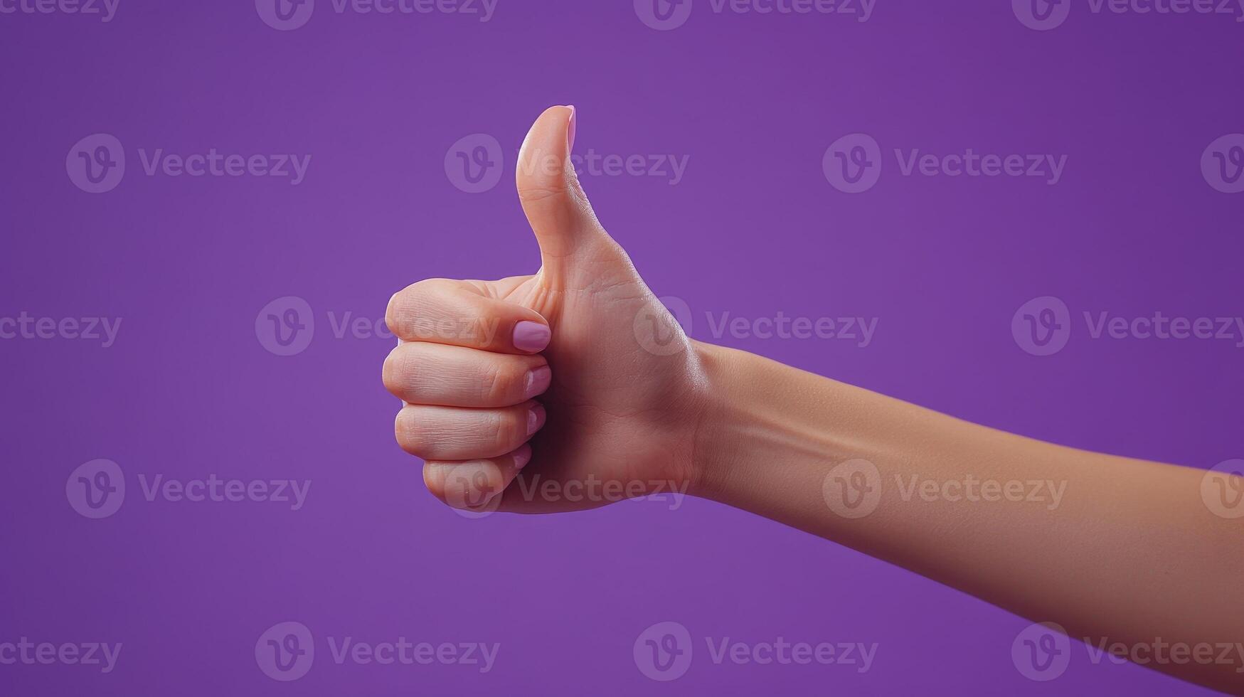 A Hand Giving a Thumbs Up Gesture Against a Purple Background photo