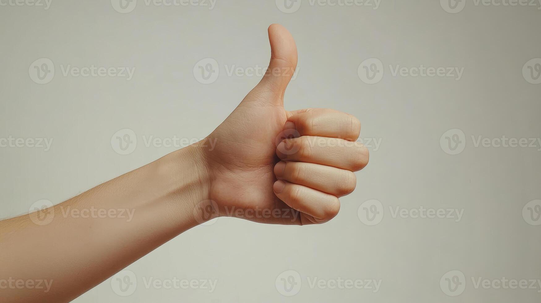 A Hand Giving a Thumbs Up Gesture photo