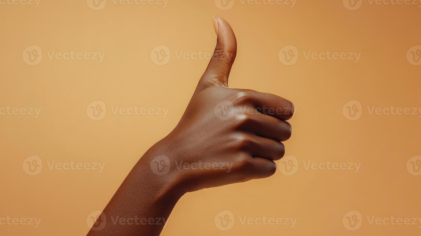 A Close-up of a Person's Hand Giving a Thumbs-Up Gesture photo
