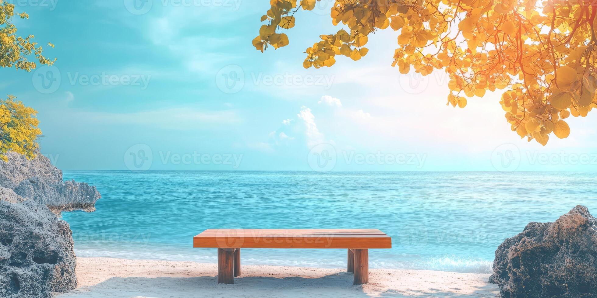 Wooden Bench on a Sandy Beach with a Turquoise Ocean and Yellow Tree Branches photo