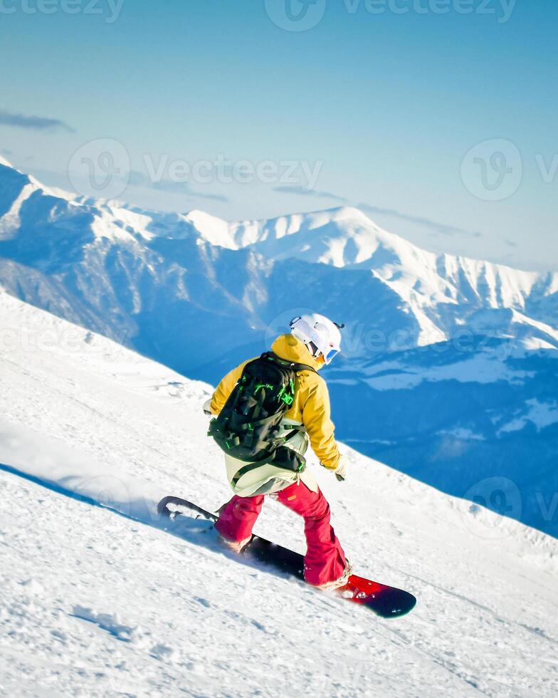Side view male skier wear colorful outfit isolated on piste ski downhill fast motion in Alps. Active winter holidays, skiing downhill in overcast day. Ski rides on the track with swirls of fresh snow photo