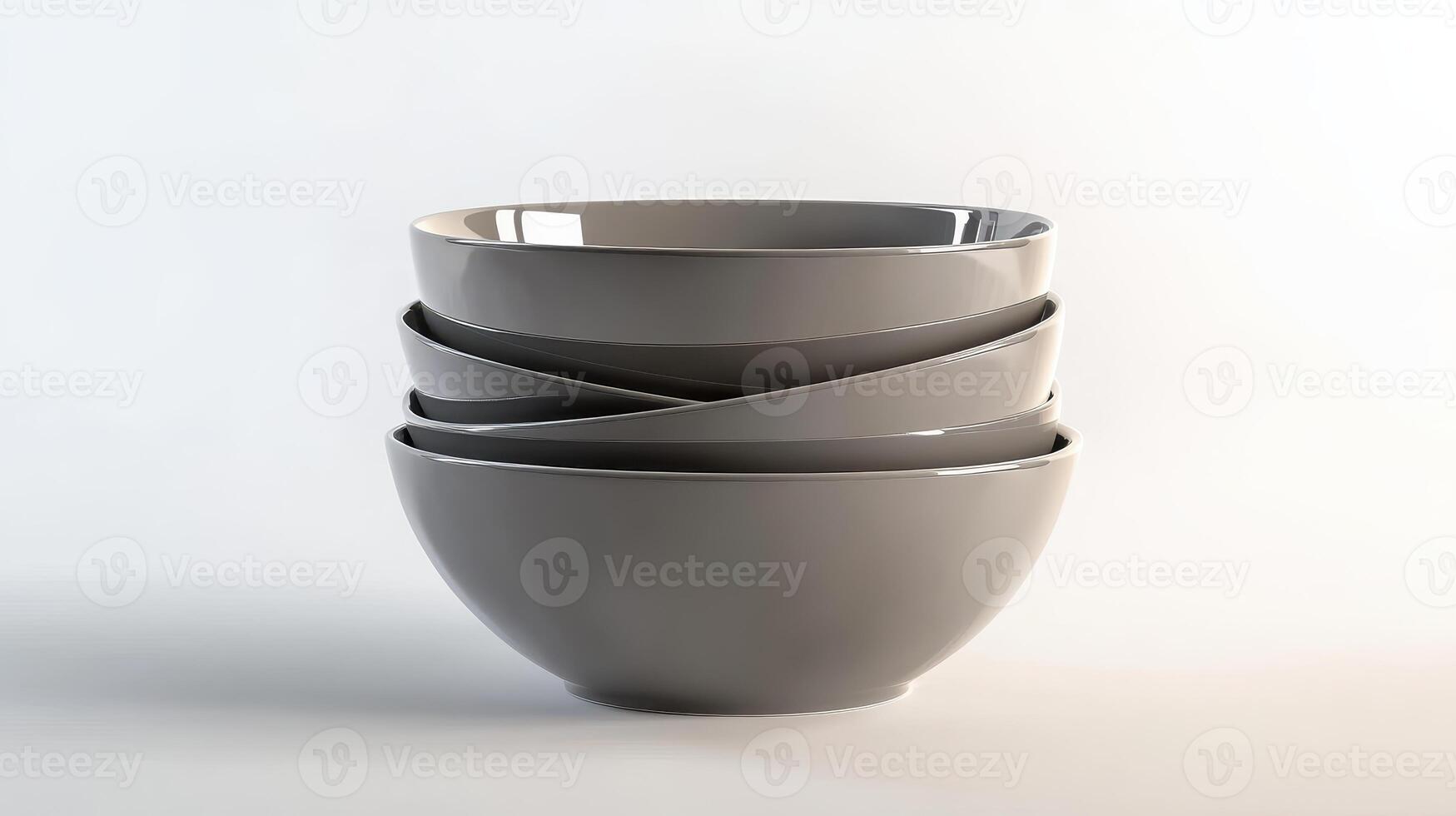 Stack of four modern gray ceramic bowls arranged artistically on a light background photo