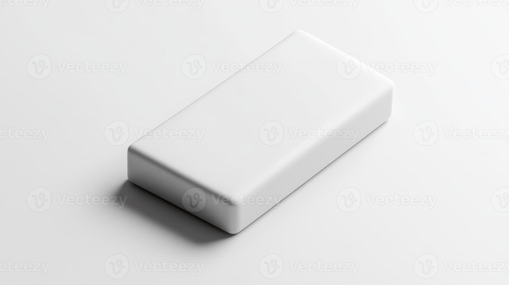 Plain white eraser resting on a smooth surface in a well-lit environment photo