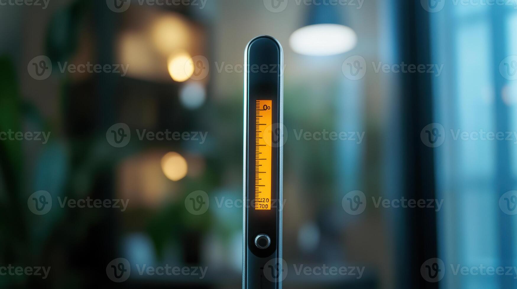 A digital measuring tool with an illuminated scale, captured indoors during evening hours photo