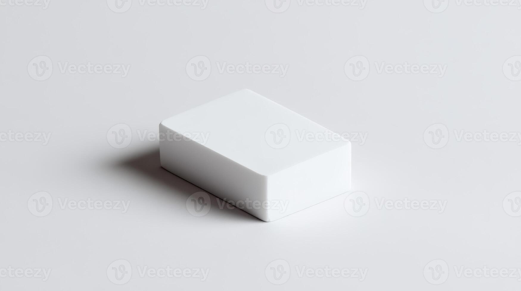 Simple white eraser resting on a clean surface, capturing natural light from above in a minimalistic setting photo