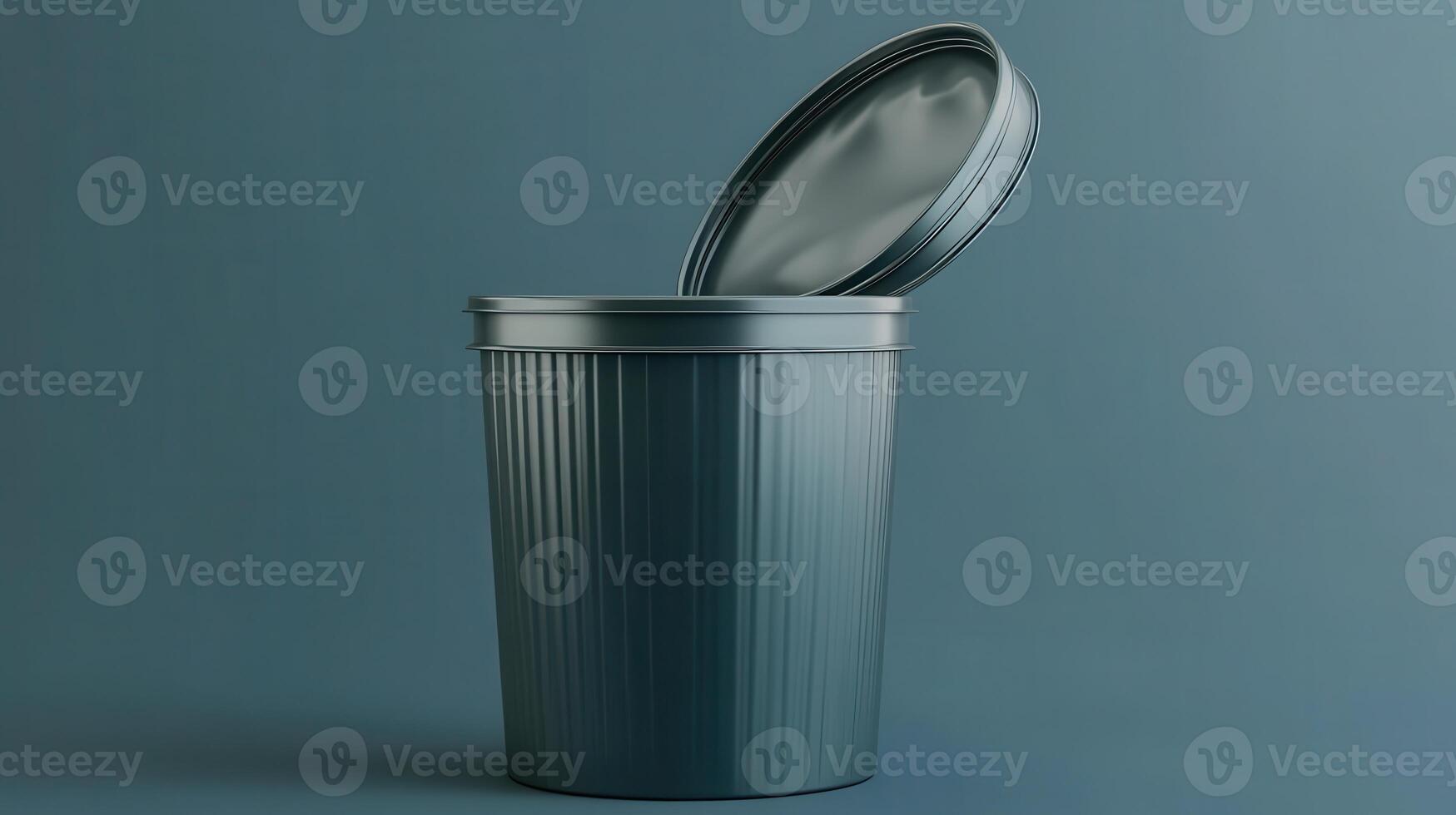Metal waste bin with an open lid set against a blue background photo