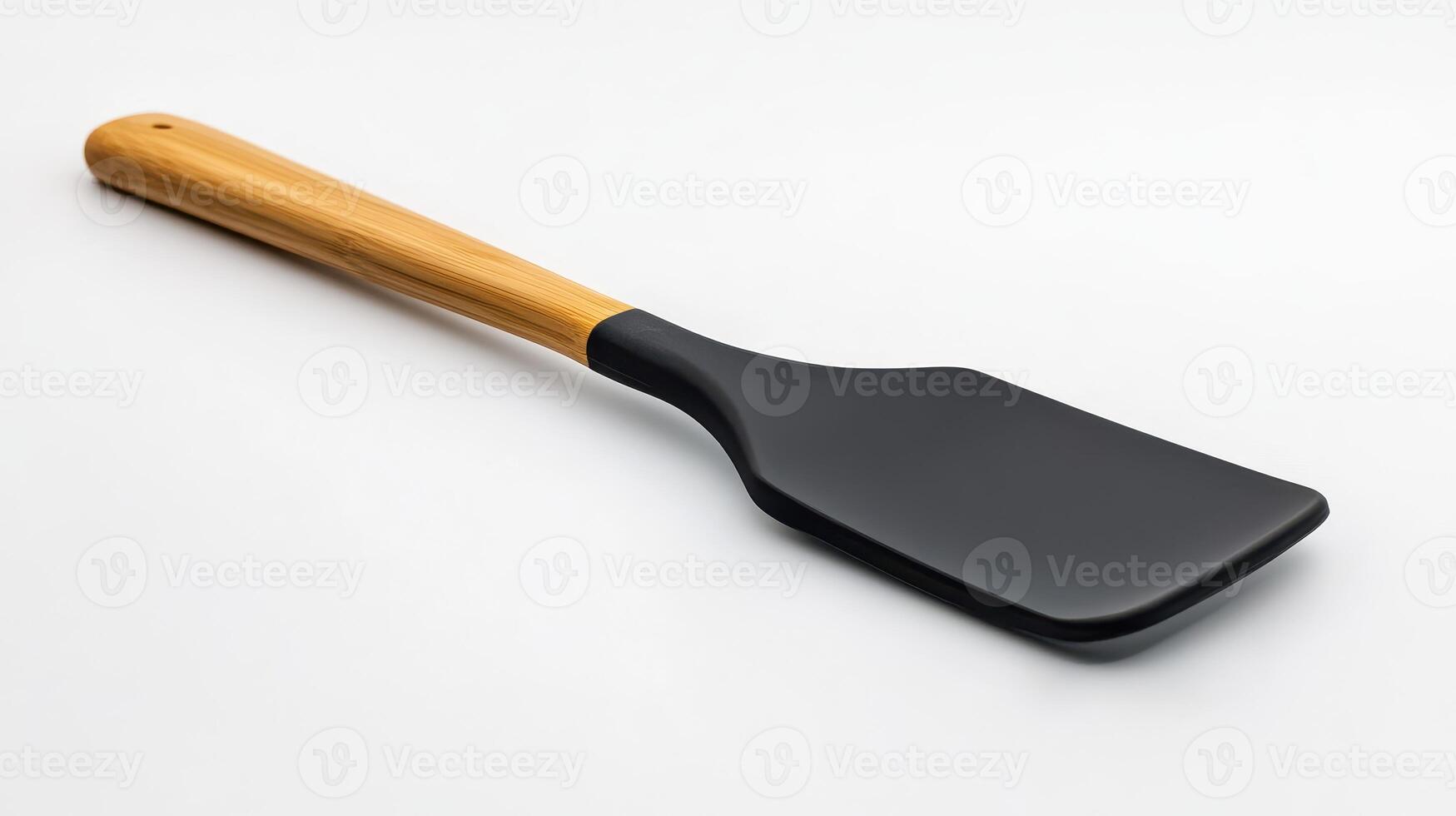 Black spatula with wooden handle isolated on a white background photo
