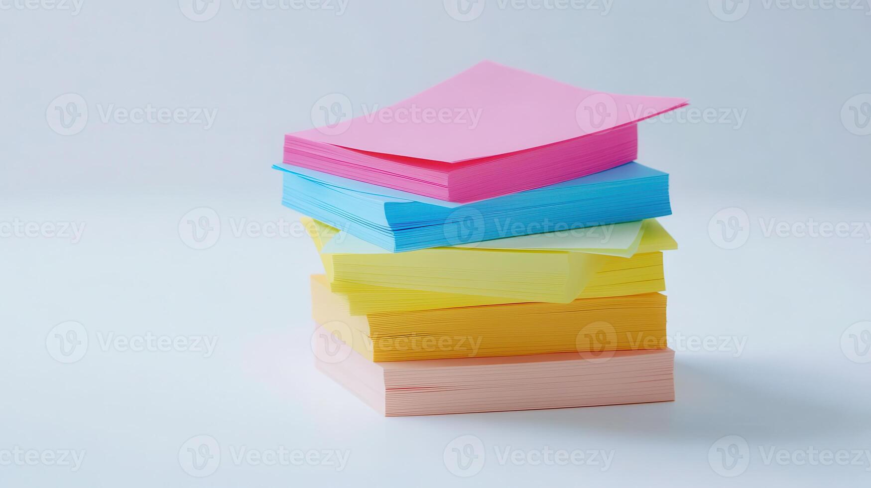 Stacked colorful note papers arranged neatly on a white surface photo