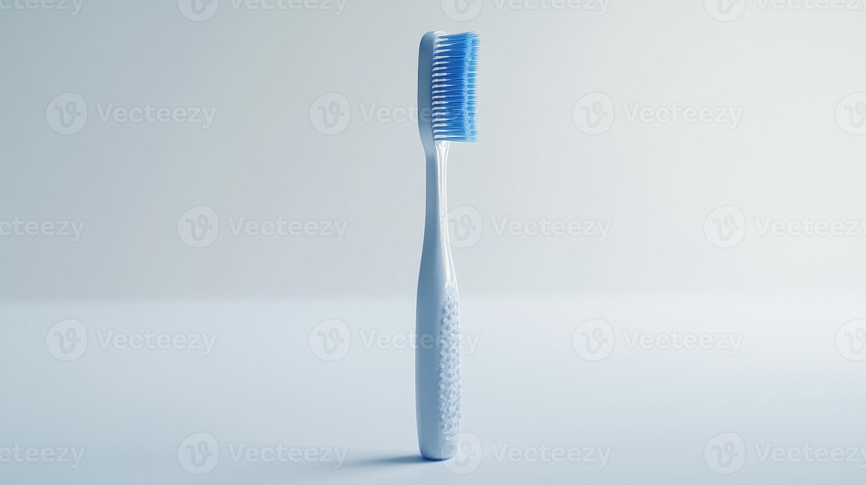 A simple blue toothbrush stands upright against a soft white background, showcasing its bristles and ergonomic design photo