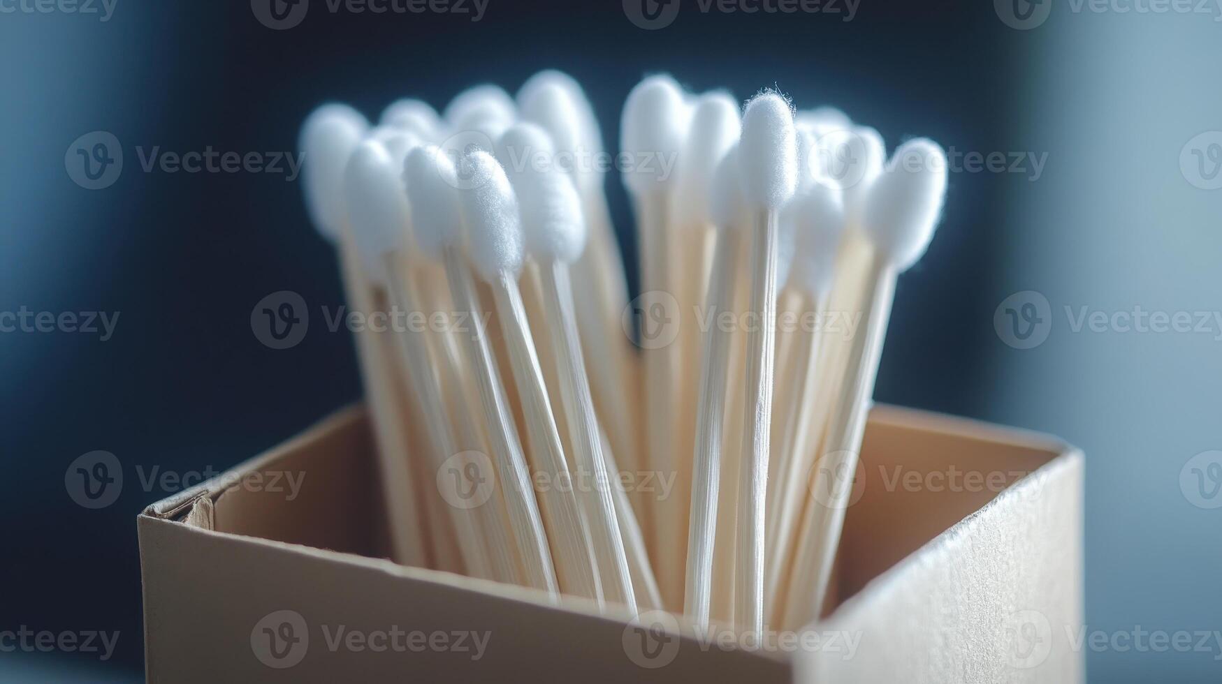 Collection of cotton swabs in a cardboard box on a flat surface in a well-lit room photo