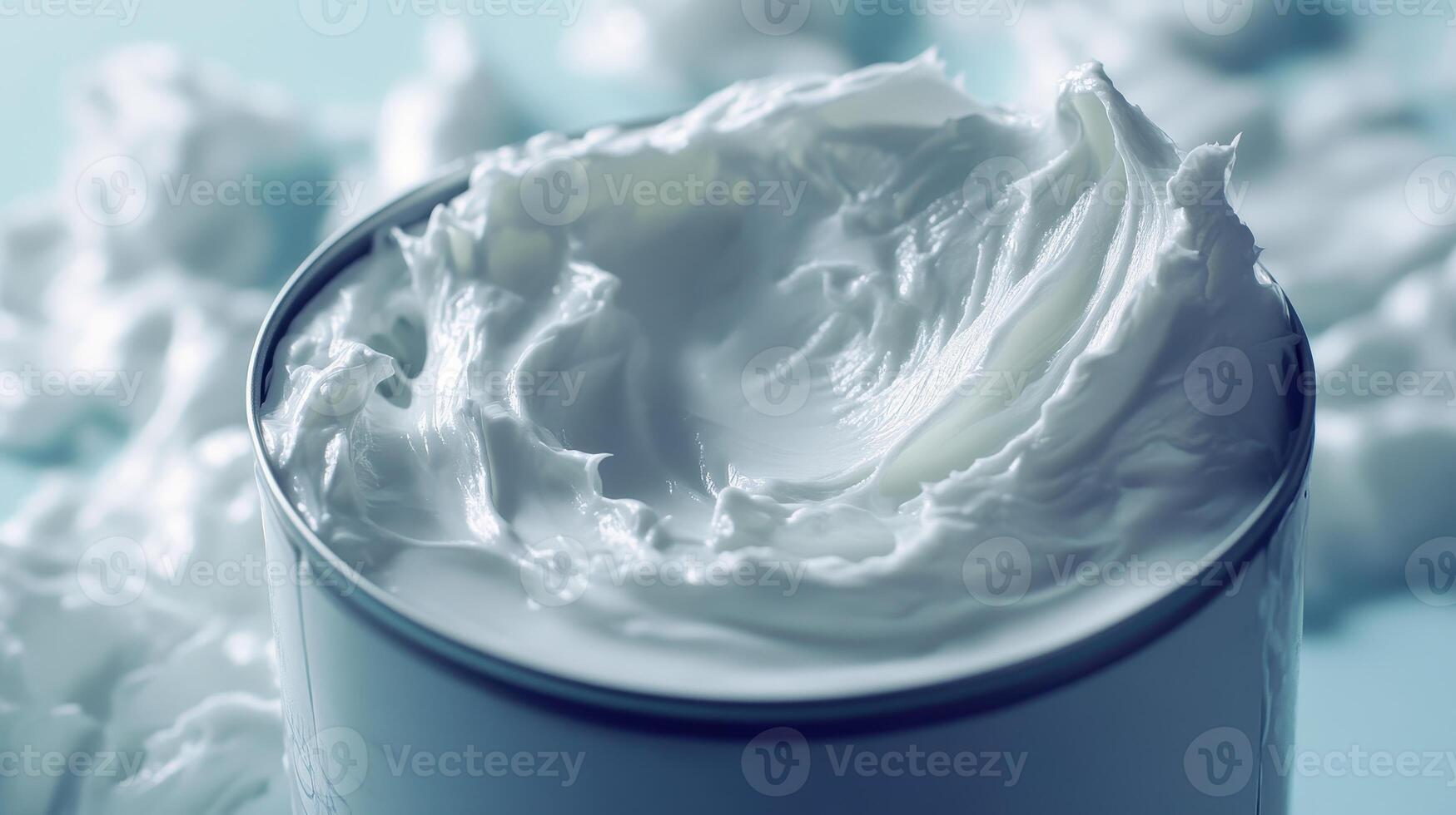 Creamy whipped topping in a bowl with fluffy texture against a soft blue backdrop photo