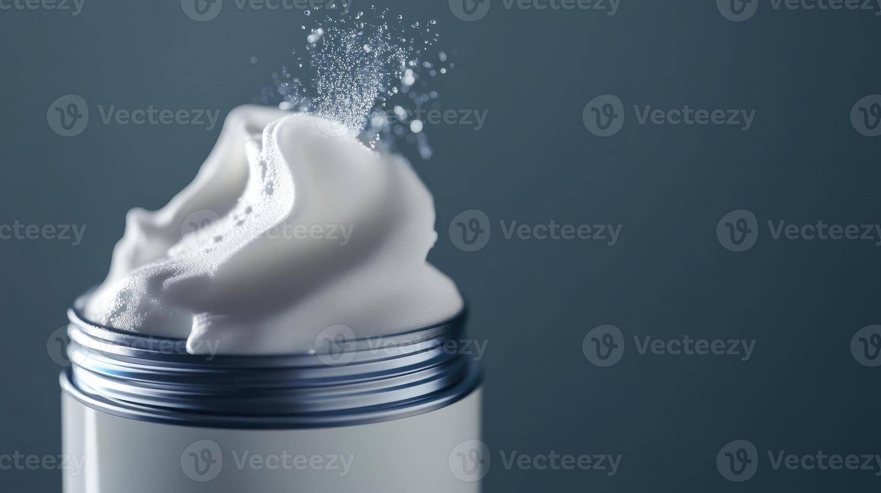 Whipped cream topped with a sprinkle of sugar in a silver container against a blue background photo