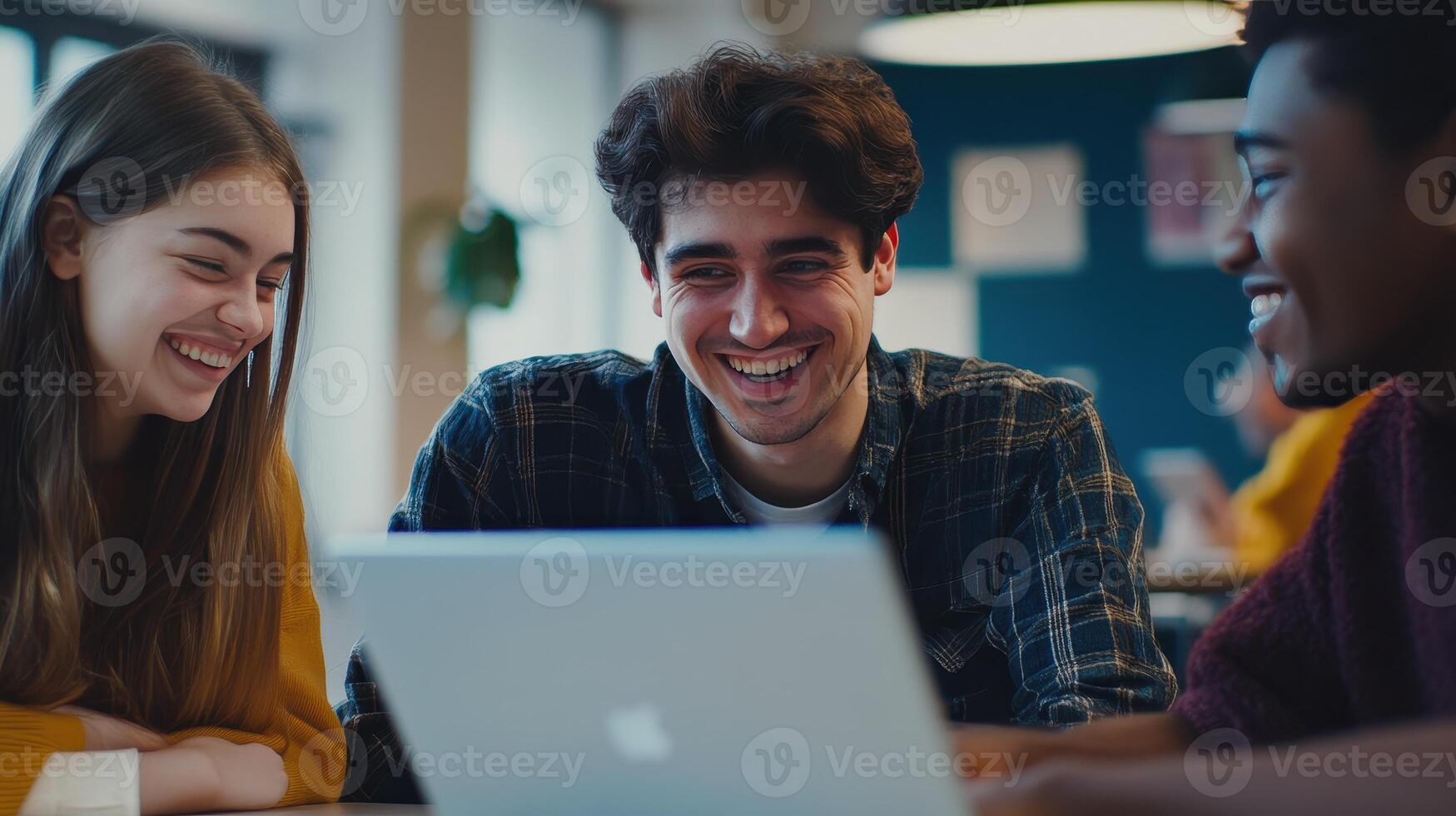 Three University Students Collaborate on a Project While Enjoying a Laugh in a Cozy Cafe photo