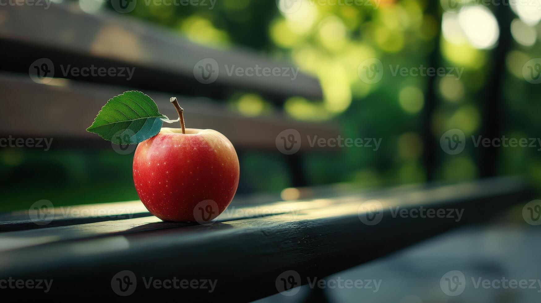A Bright Red Apple Resting on a Weathered Bench in a Tranquil Park During Late Afternoon Light photo