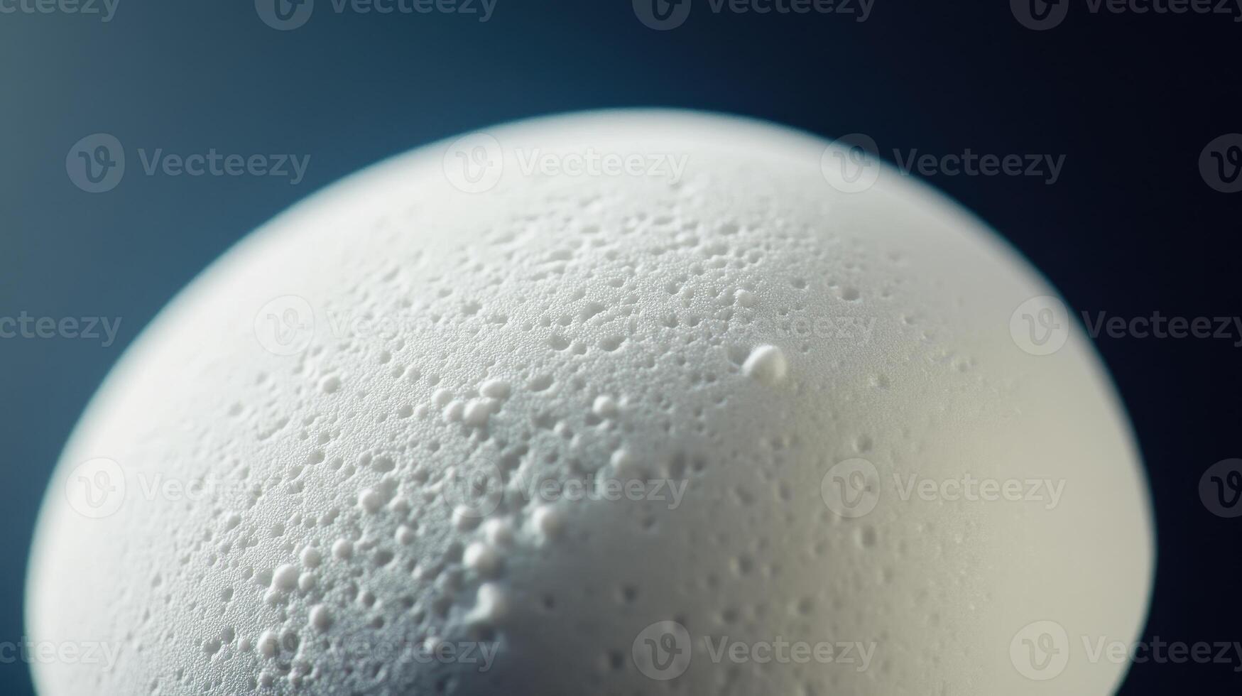 Close-Up of a Fresh Egg With Droplets and Texture Under Soft Lighting in a Studio Setting photo