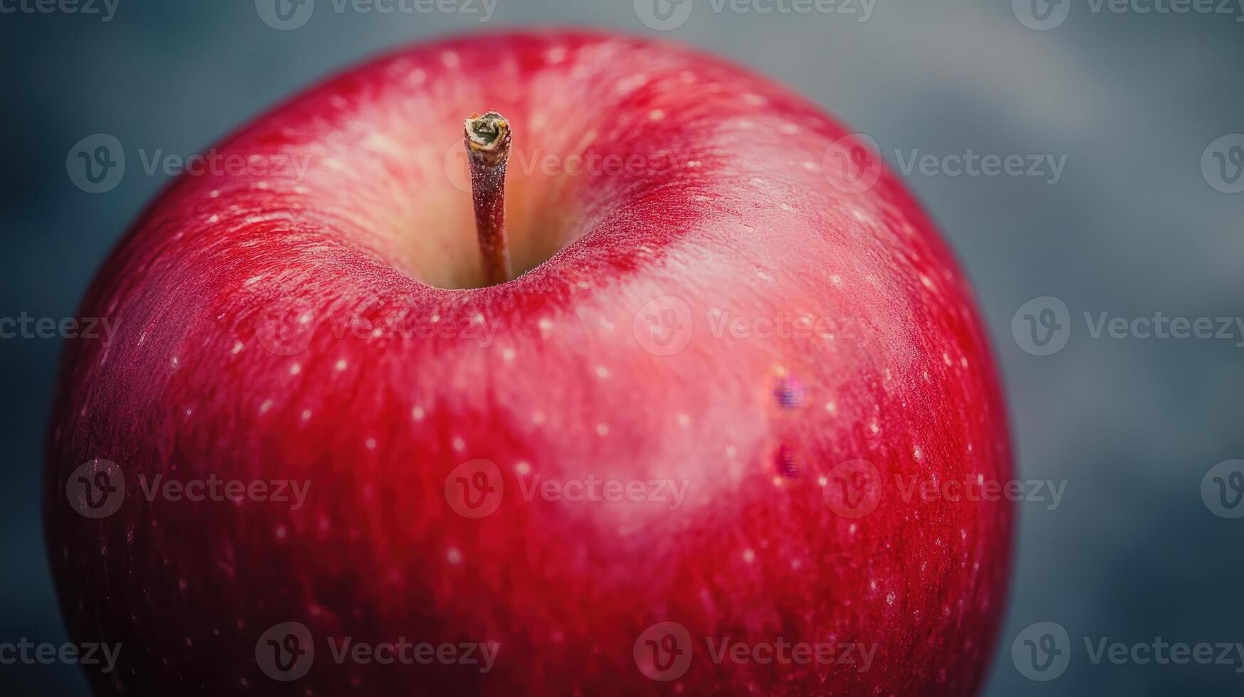 A Close-Up View of a Fresh, Vibrantly Red Apple on a Dark Background photo