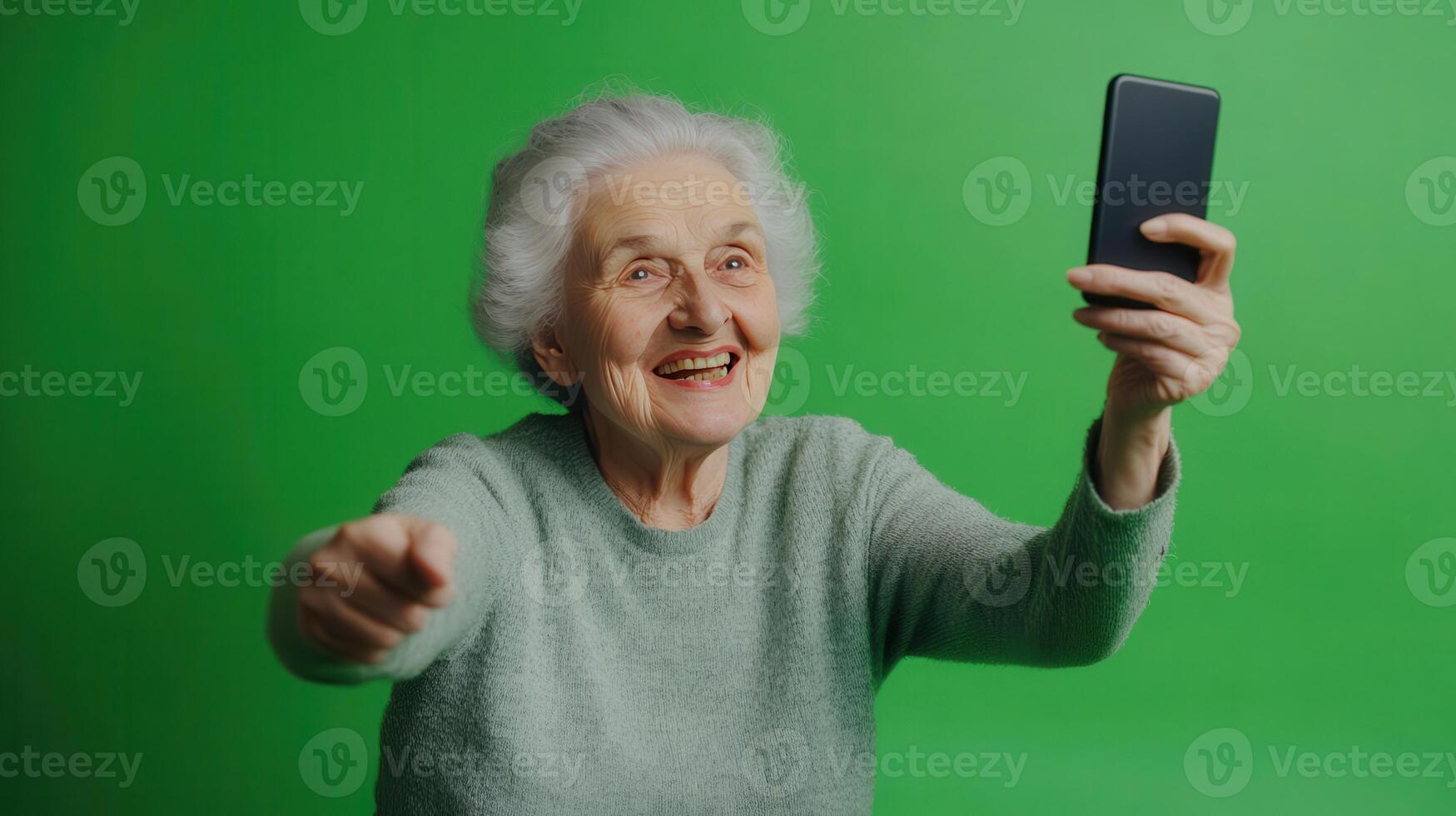 Elderly woman smiling and taking a selfie against a vibrant green backdrop photo