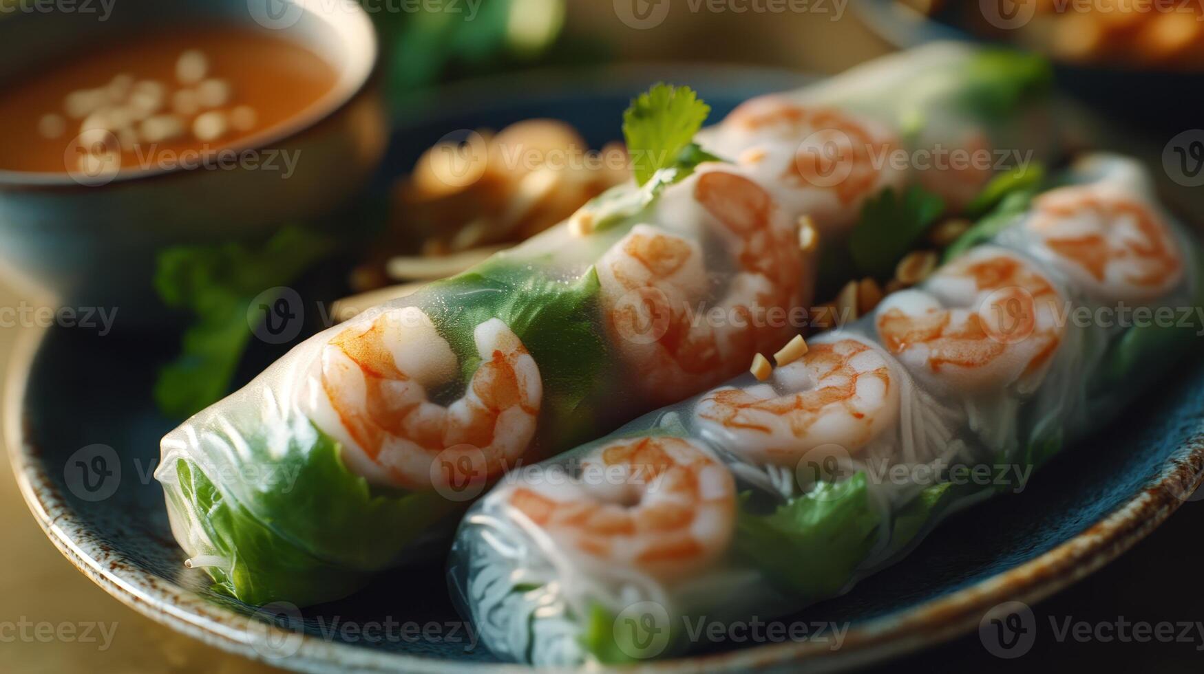 Fresh shrimp spring rolls served on a blue plate with dipping sauce and garnishes in a warm, inviting setting photo