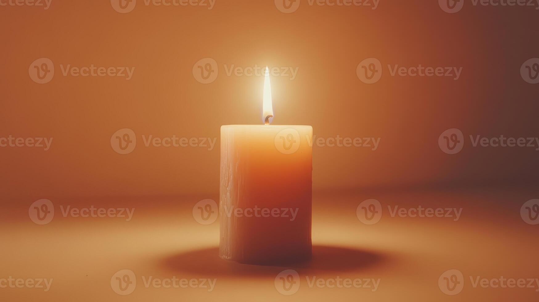 A single glowing candle casts a warm light against a soft backdrop in a tranquil setting photo