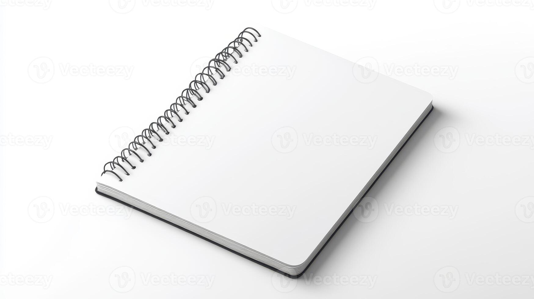 A blank spiral notebook resting on a clean surface ready for notes and sketches photo