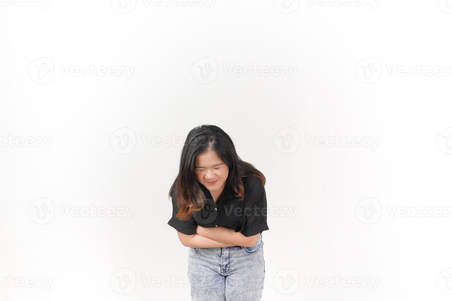 Young Asian woman suffering stomachache wearing Black t-shirt and jeans isolated on white background photo