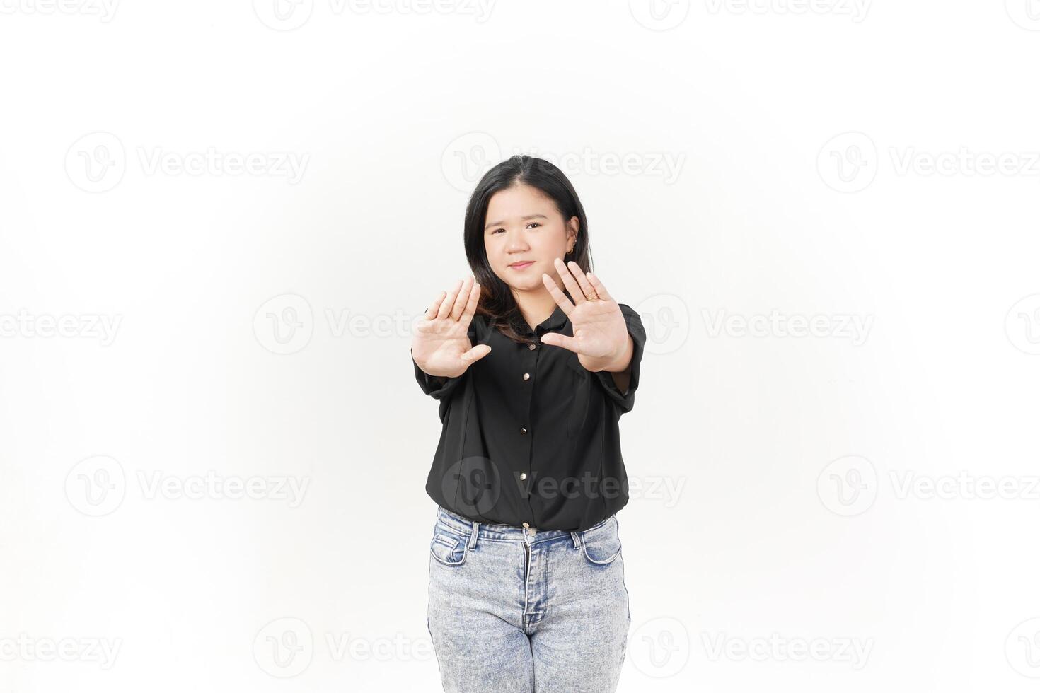 Young Asian woman doing stop or rejection sign with palm hand wearing Black t-shirt and jeans isolated on white background photo
