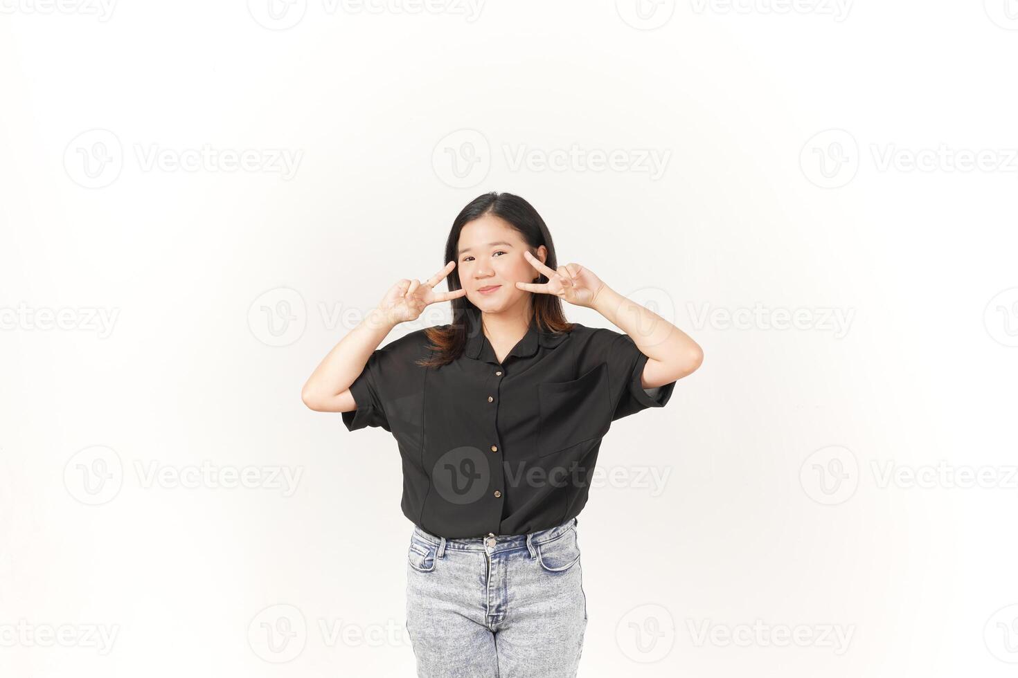 Young Asian woman showing peace sign two finger wearing Black t-shirt and jeans isolated on white background photo