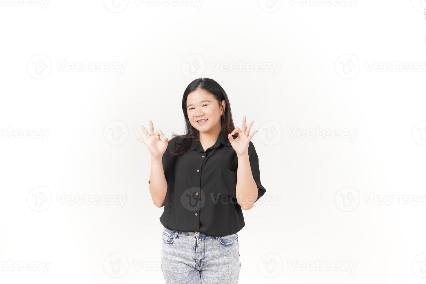 Young Asian woman showing okay sign wearing Black t-shirt and jeans isolated on white background photo