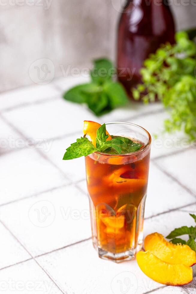 Cold ice tea with peach and mint photo