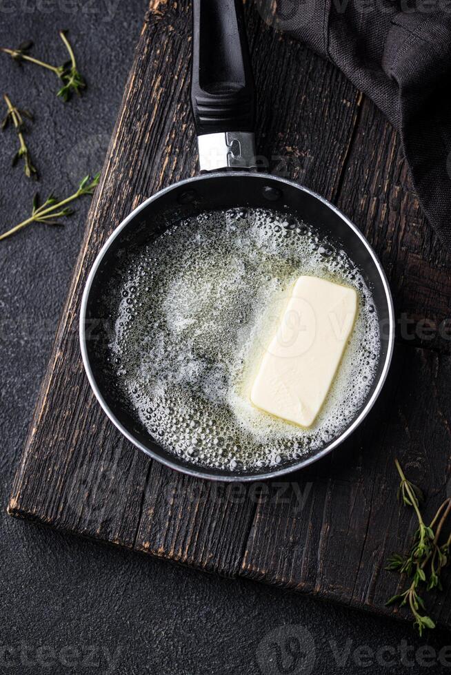 Melted butter on in iron pan photo