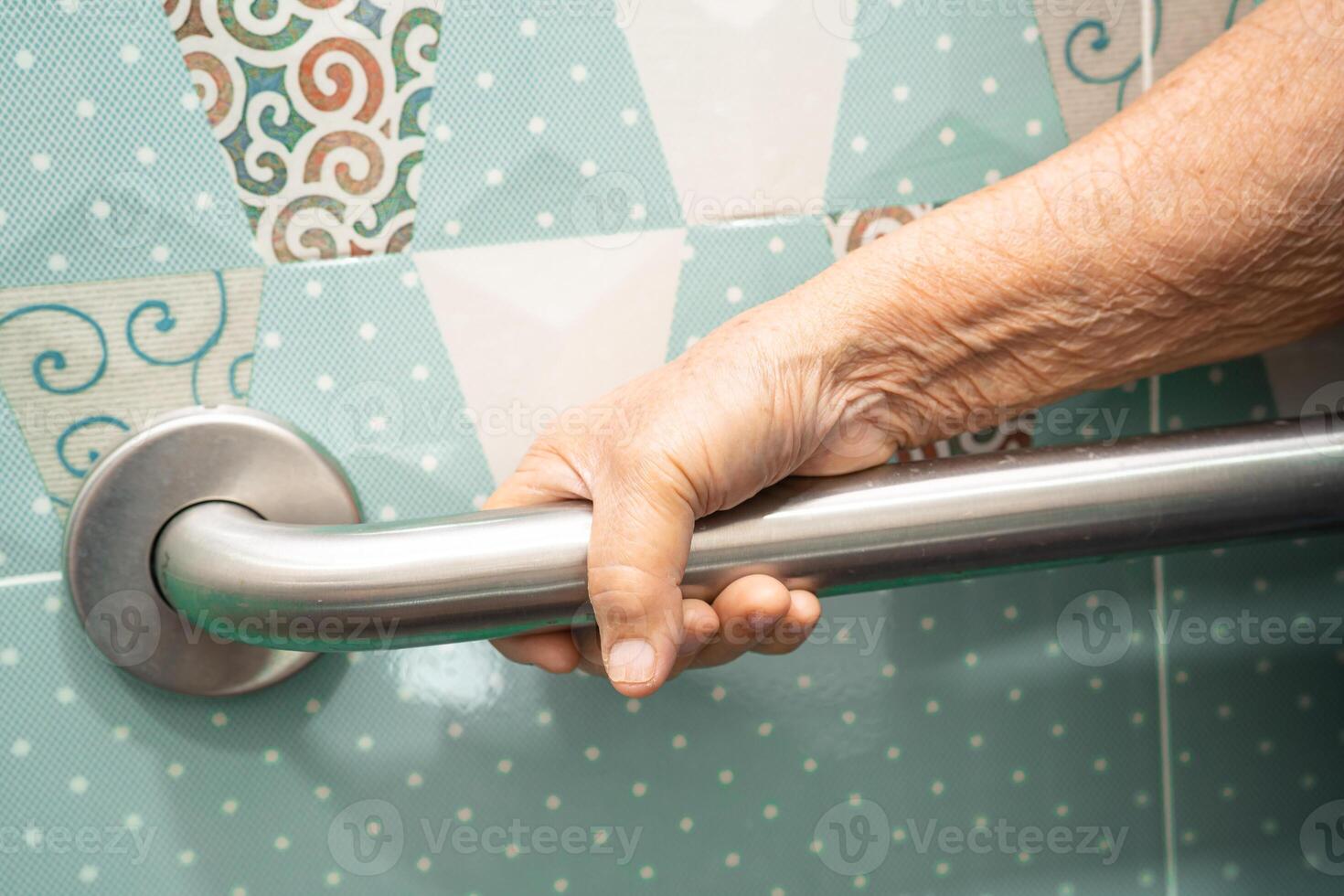 Asian elderly woman patient use toilet bathroom handle security in nursing hospital, healthy strong medical concept. photo