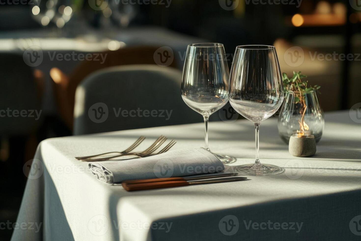 Elegant dining setup with gray linen and glassware photo