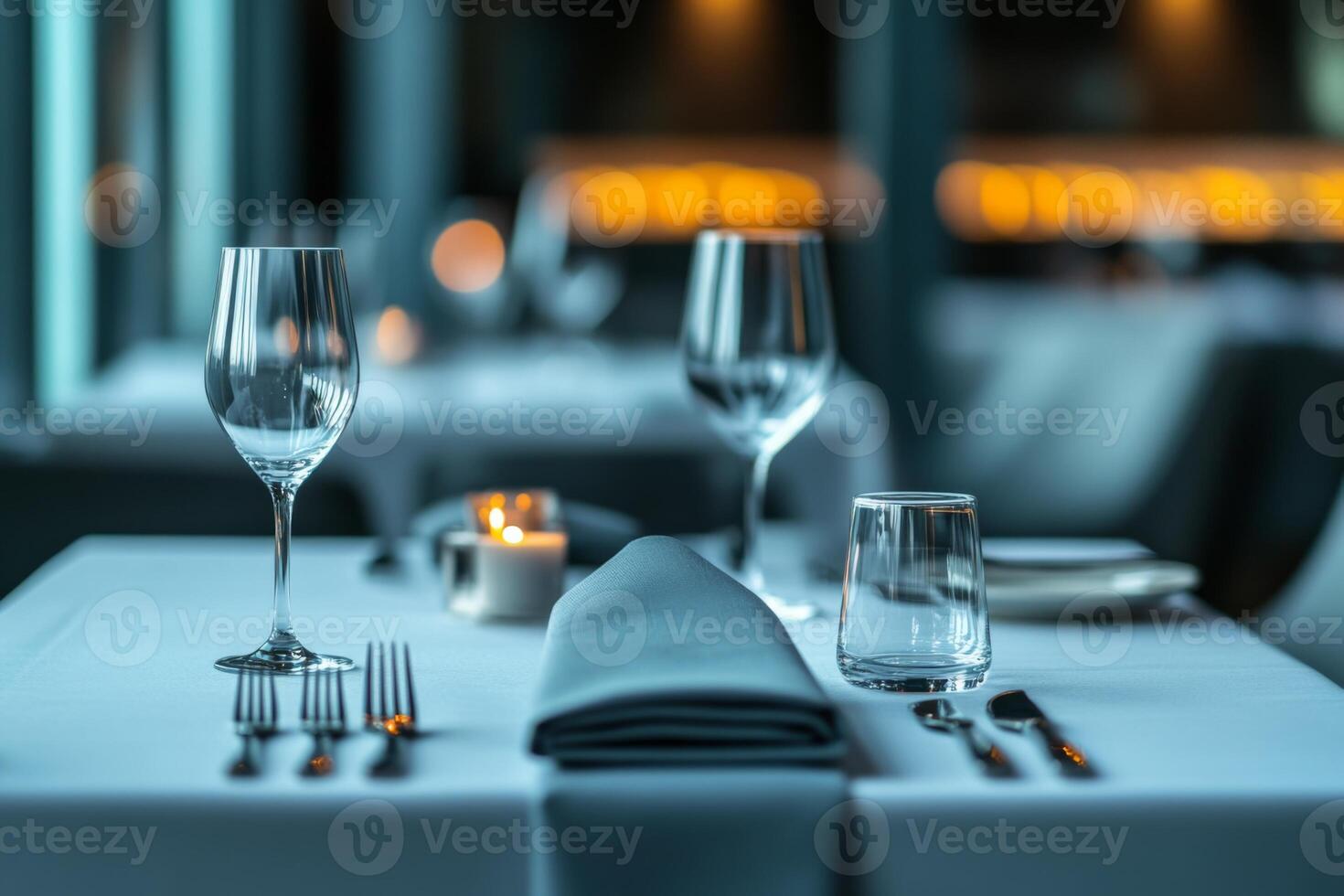 Elegant dining setup with gray linen at dusk photo