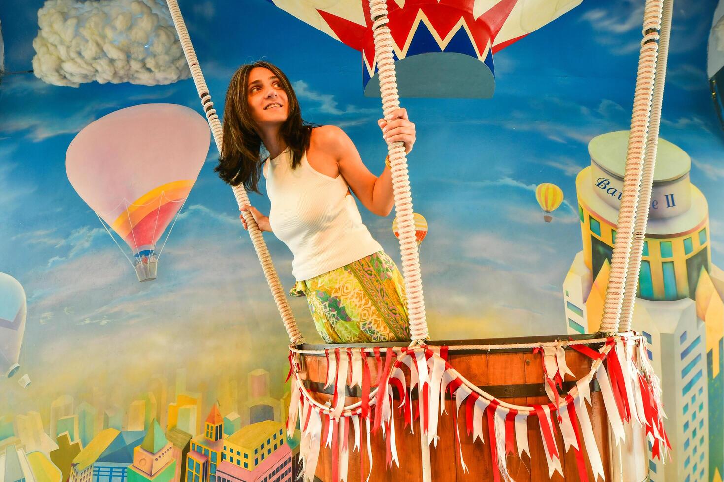 Bangkok, Thailand - 11th february, 2024 - isolated young caucasian woman pose flying on air balloon imitation in Baiyoke Sky Tower photo