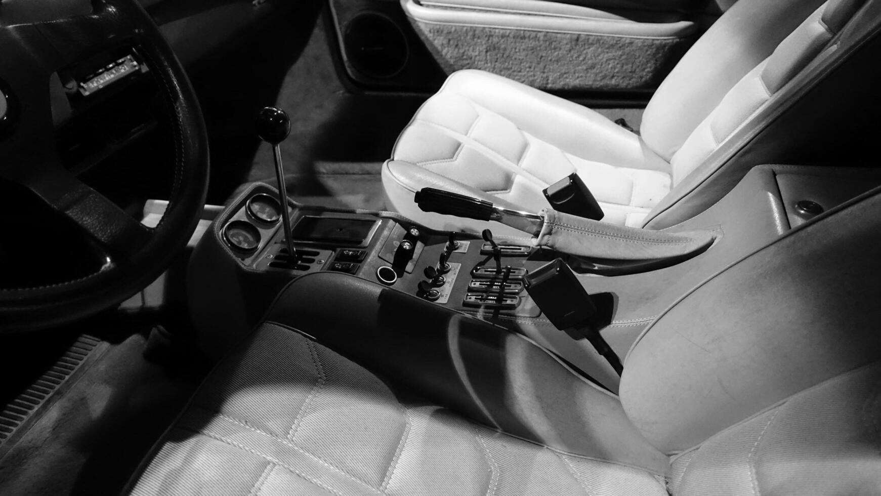 Turin, Italy - June 20, 2021. The handlebar and dashboard of an antique automobile at Automobile Museum. photo