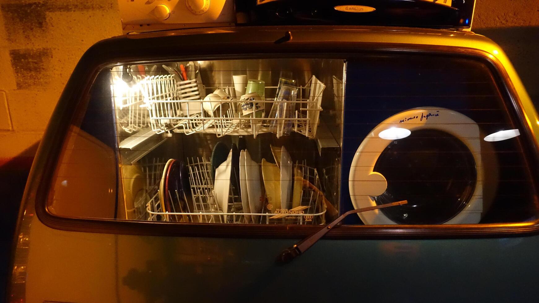 Turin, Italy - June 20, 2021. A washing machine and dishwasher built into an Italian automobile at Automobile Museum. photo