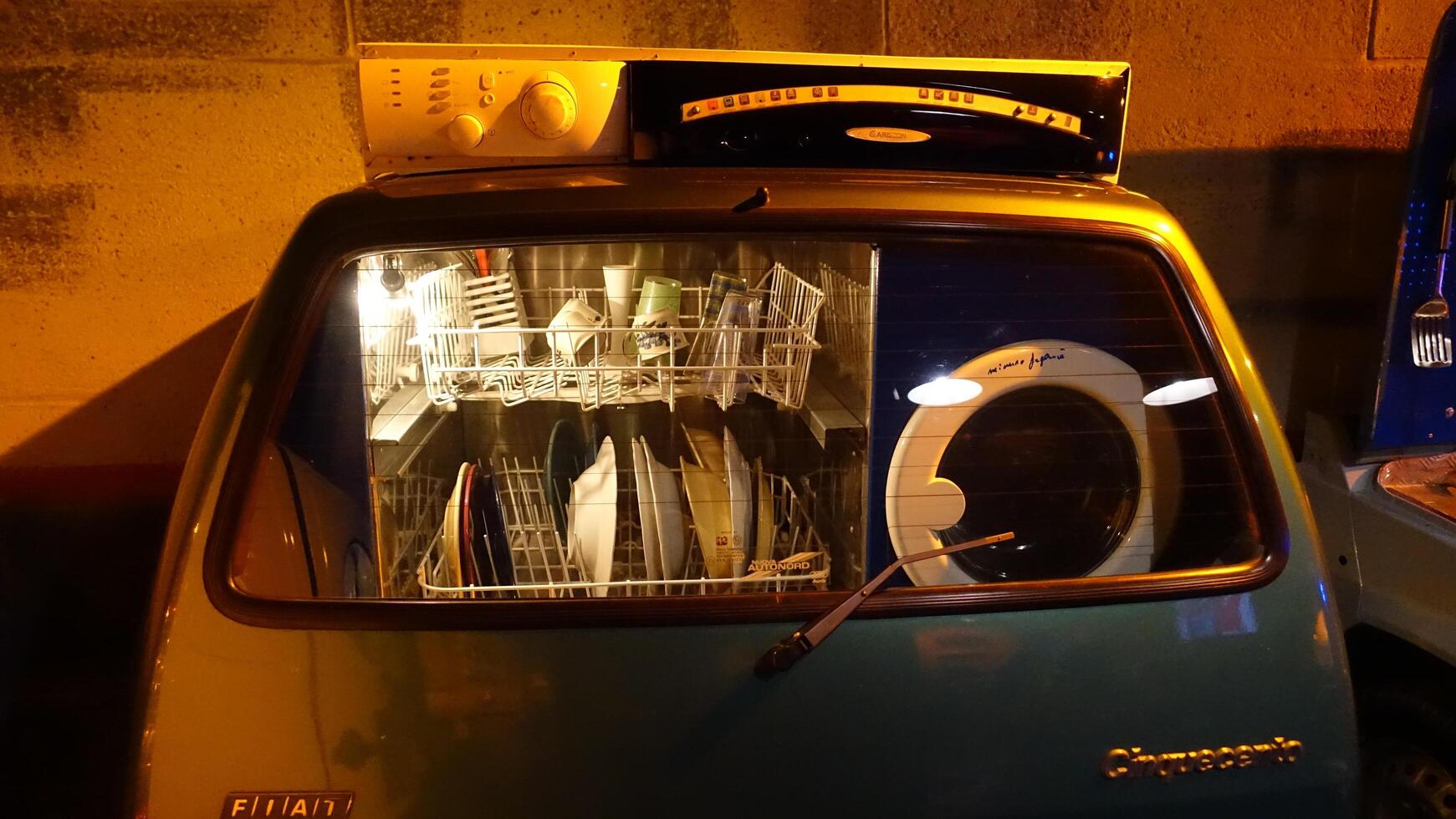 Turin, Italy - June 20, 2021. A washing machine and dishwasher built into an Italian automobile at Automobile Museum. photo