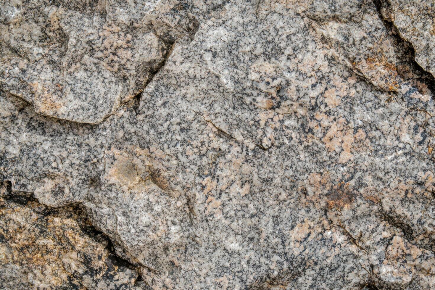 A granite texture background showcases a rugged, speckled surface with natural variations in color and pattern photo