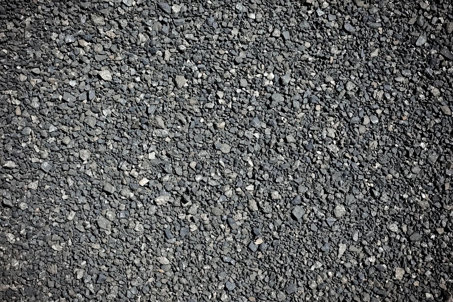 A rugged and dark asphalt texture background with a slightly rough surface photo