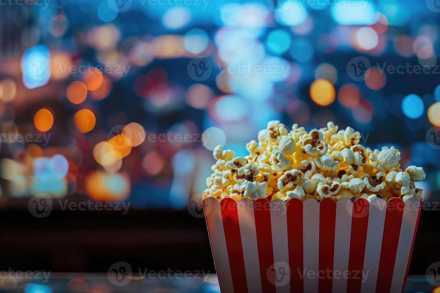 A classic box of popcorn for watching a movie on the big screen, food for the cinema, a large TV, a fun pastime. photo