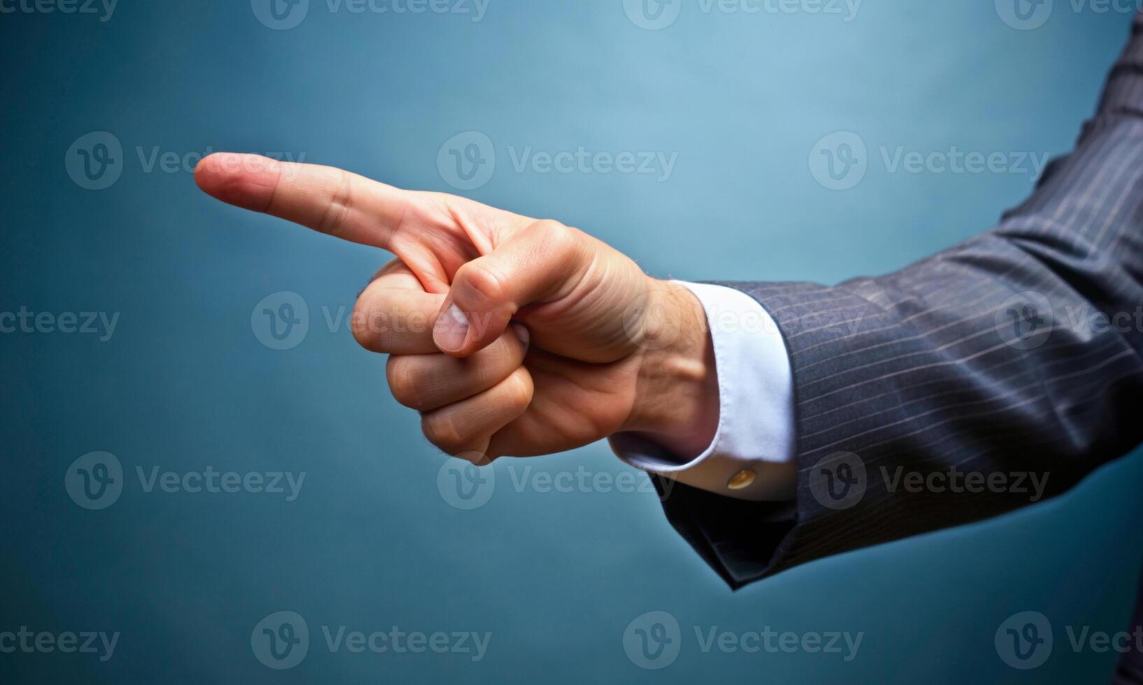 The businessman's index finger points to something in space photo