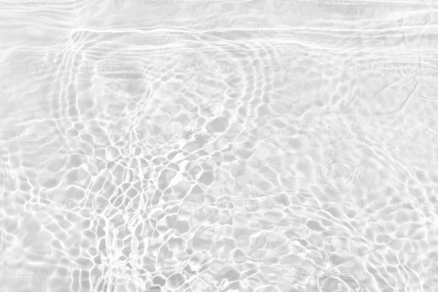 Bluewater waves on the surface ripples blurred. Defocus blurred transparent blue colored clear calm water surface texture with splash and bubbles. Water waves with shining pattern texture background. photo