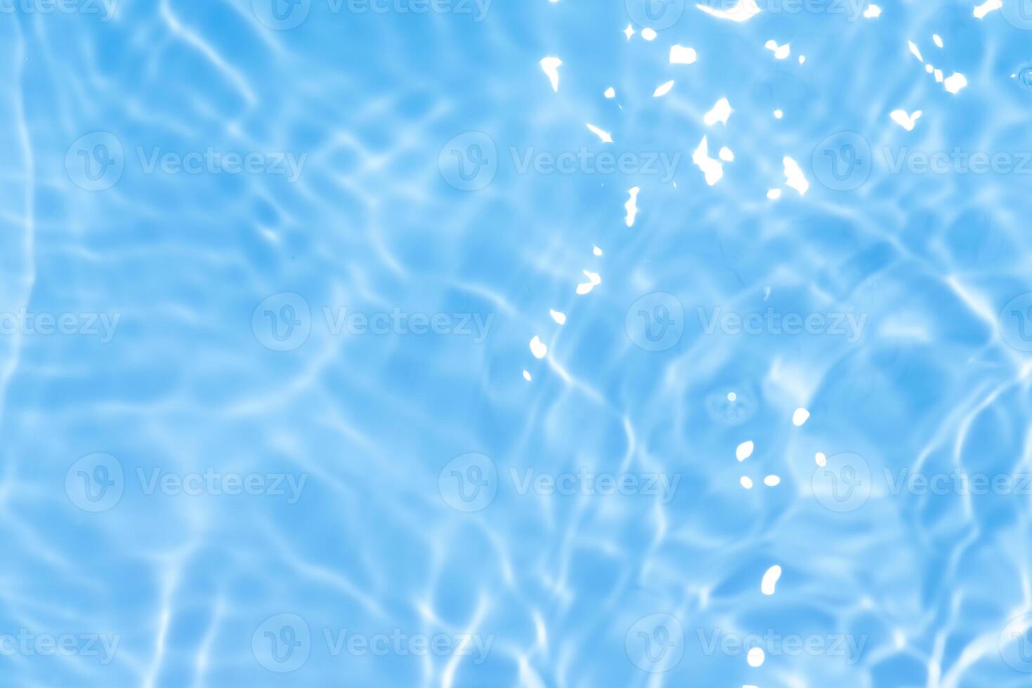 Bluewater waves on the surface ripples blurred. Defocus blurred transparent blue colored clear calm water surface texture with splash and bubbles. Water waves with shining pattern texture background. photo