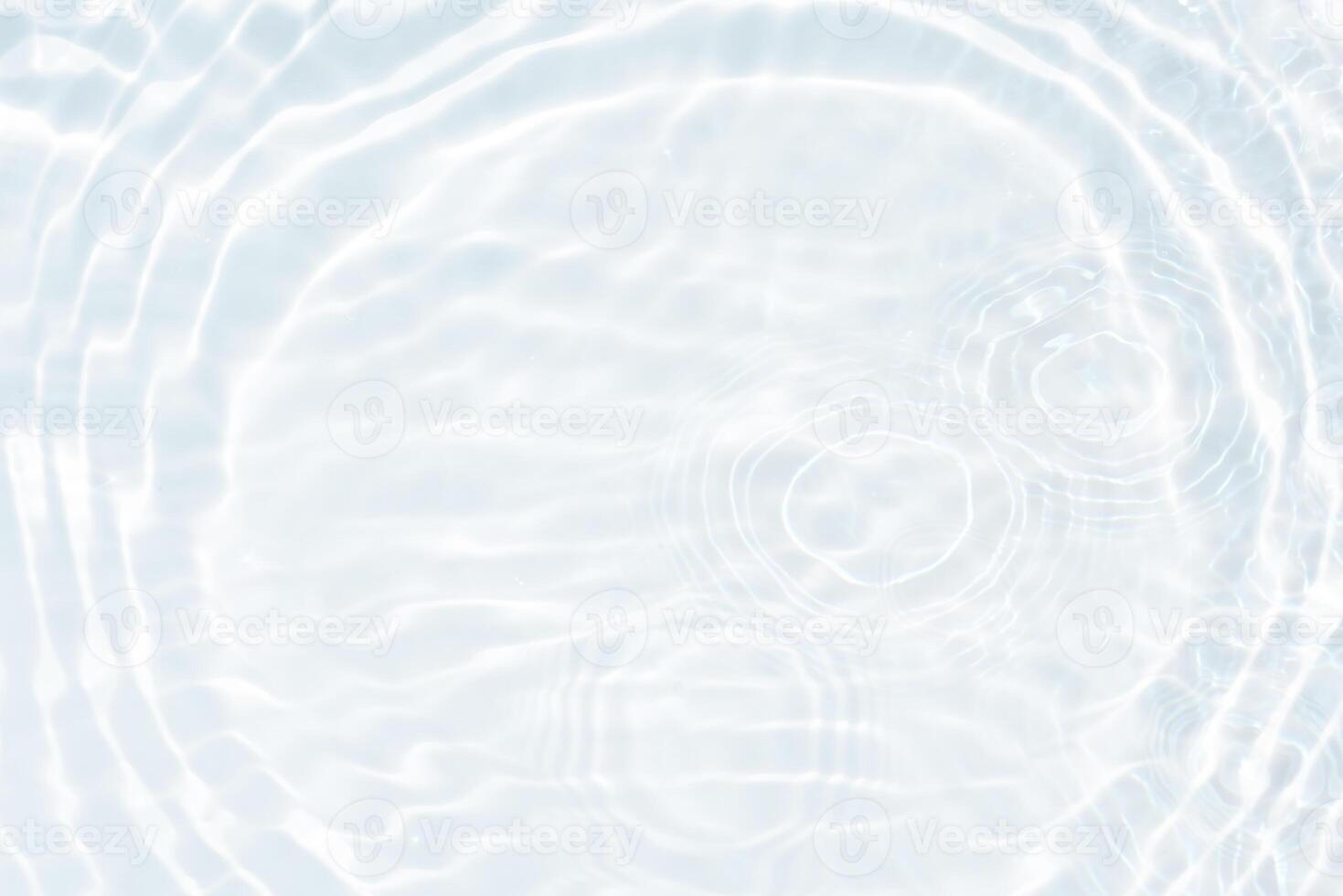 Bluewater waves on the surface ripples blurred. Defocus blurred transparent blue colored clear calm water surface texture with splash and bubbles. Water waves with shining pattern texture background. photo