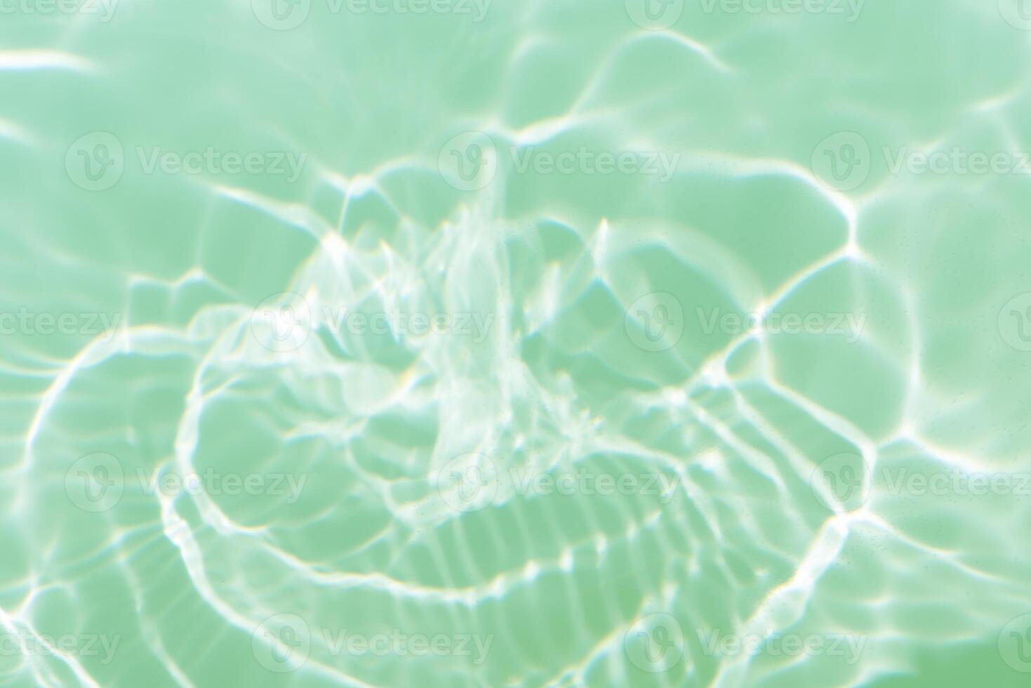 Bluewater waves on the surface ripples blurred. Defocus blurred transparent blue colored clear calm water surface texture with splash and bubbles. Water waves with shining pattern texture background. photo